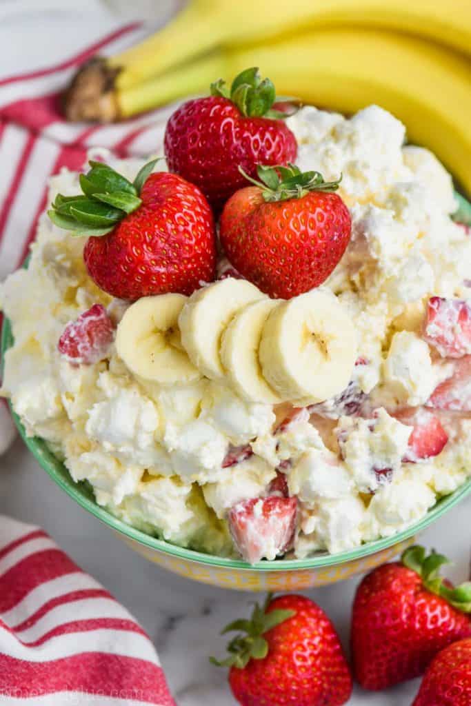 overhead view of strawberry banana fluff recipe in a bowl with fresh strawberries and bananas